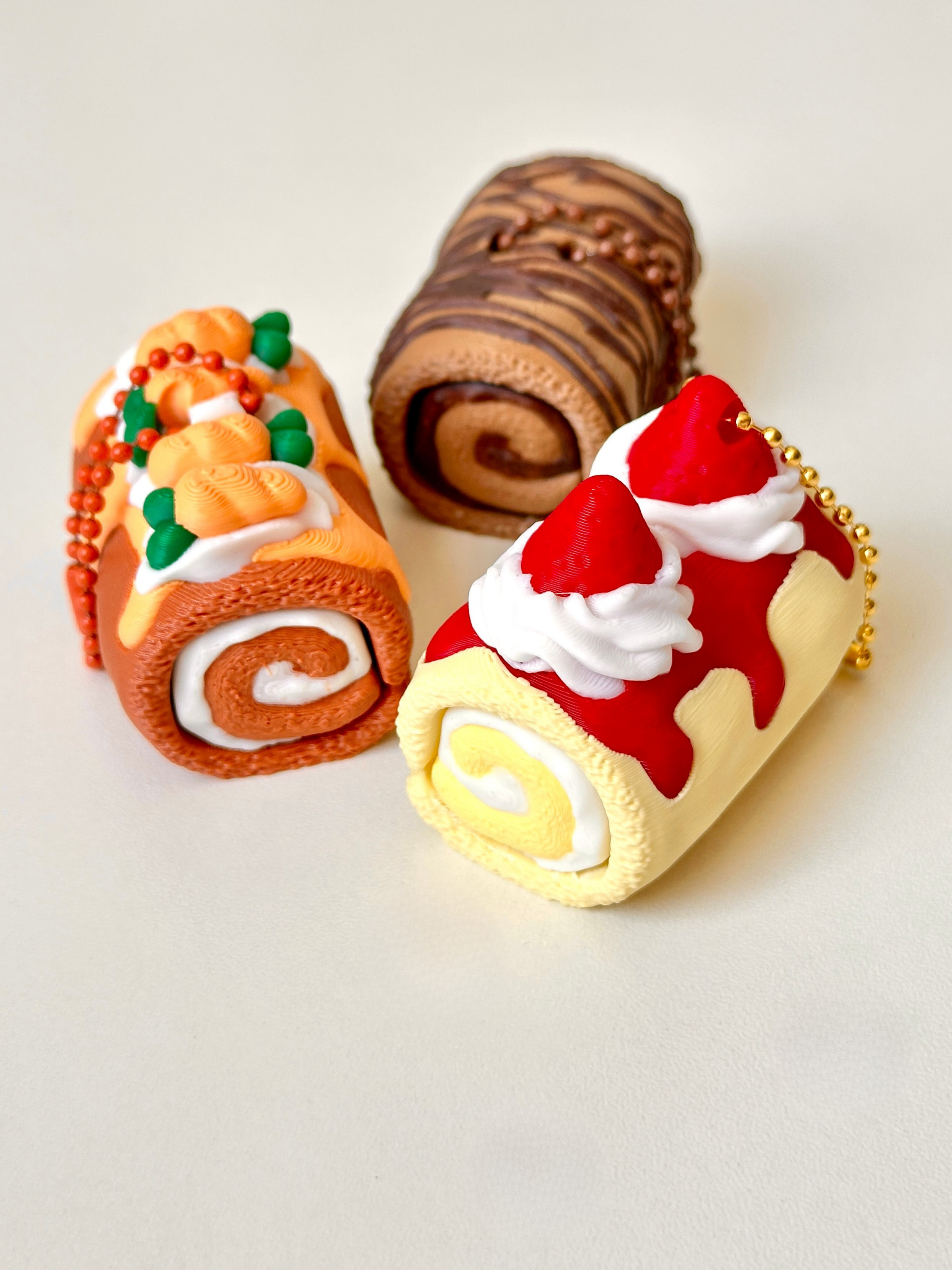 3D Printed Swiss Roll Cake Clicker Keychains – Carrot Cake, Strawberry Cream & Chocolate | Dubai 3D Printing