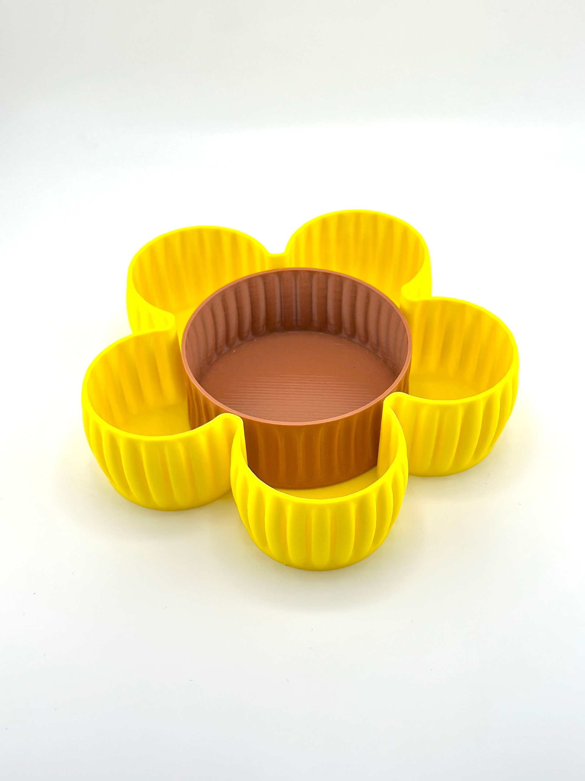 Front-facing image of Al Samer Flower Catch-All Tray with white background, showing full shape, yellow petal design, and brown center dish