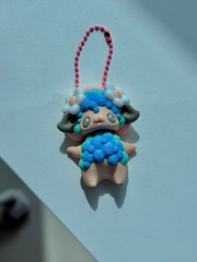 Front-facing 3D printed sheep bag charm with pastel rainbow body and white flower details on both ears