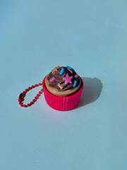 3D printed chocolate cupcake with pink sleeves fidget keychain with rich frosting detail, shown on a white background