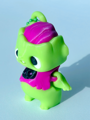 Close-up of zombie charm’s face and pink exposed brain with funny expression and tooth detail