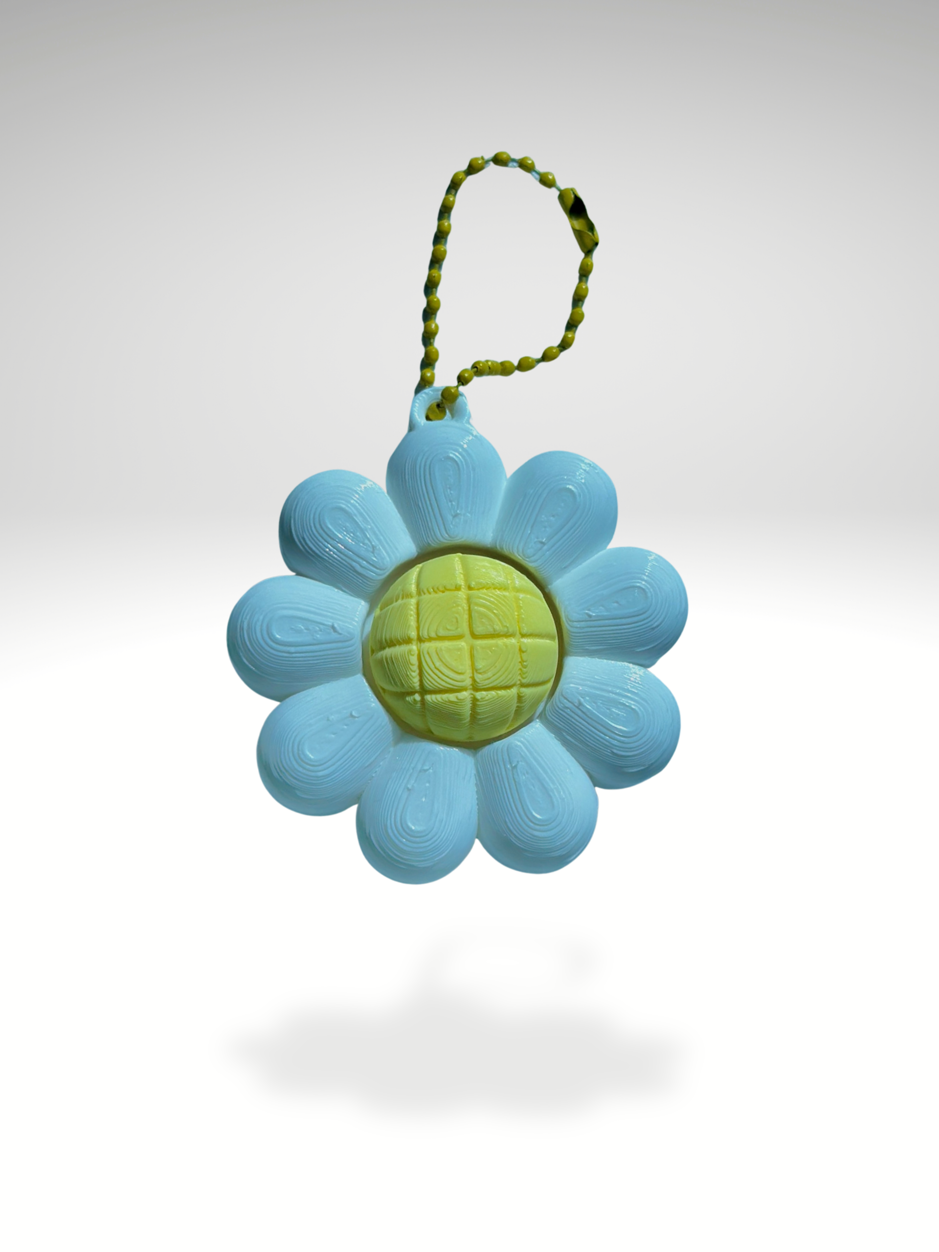 3D printed daisy-shaped clicker keychain with white petals and a yellow clickable center, displayed on a clean white background