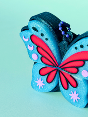 Galaxy black dark pixie fidget toy with glittery blue wings close-up view