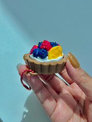3D printed fruit tart fidget toy keychain showing side view of textured tart crust and layered fruit topping