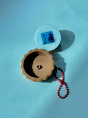 3D printed fruit tart fidget toy with top removed, exposing internal mechanical key switch for clicking action