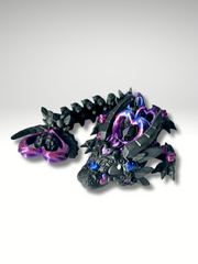 3D printed articulated Heart Dragon in Black-Purple posed in a curled position, showing front view of head, body segments, and heart-tail