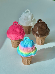 Four 3D printed one-scoop ice cream cone clicker keychains in chocolate, strawberry, vanilla, and cotton candy arranged on a flat surface