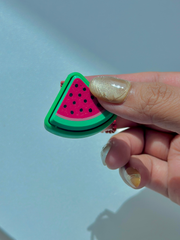 3D printed watermelon slice clicker keychain held in hand to show compact size and portable design