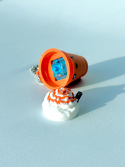 One of the pumpkin spice latte fidget toys opened to display the hidden mechanical switch inside