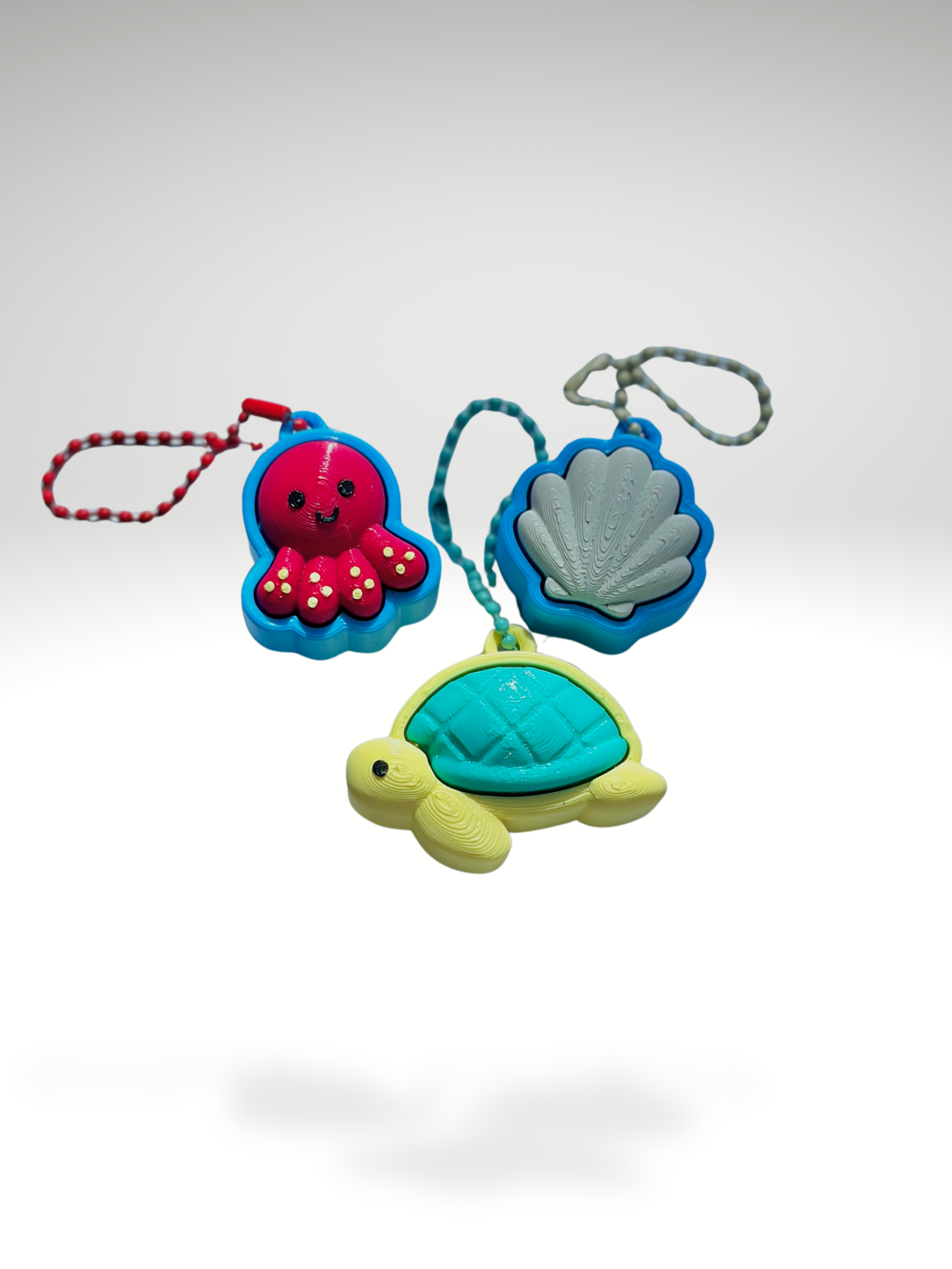 3D printed Sea Friends fidget toy keychains featuring a turtle, seashell, and octopus displayed together