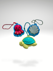 3D printed Sea Friends fidget toy keychains featuring a turtle, seashell, and octopus displayed together