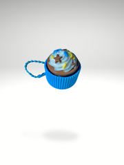 3D printed vanilla cupcake clicker with blue sleeves keychain with swirled frosting, displayed on a clean white background