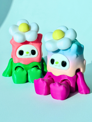 wo 3D printed Woobu Daisy Spinners in rainbow pink and green pink sitting side by side