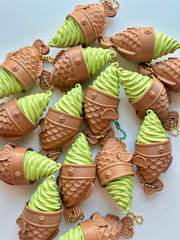 A pile of 3D printed Matcha Taiyaki Clicky Pals showing the brown taiyaki cones and green matcha soft-serve swirls | Dubai 3D Printing