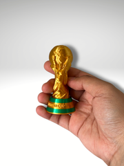 Hand holding 3D printed World Cup trophy keychain Dubai