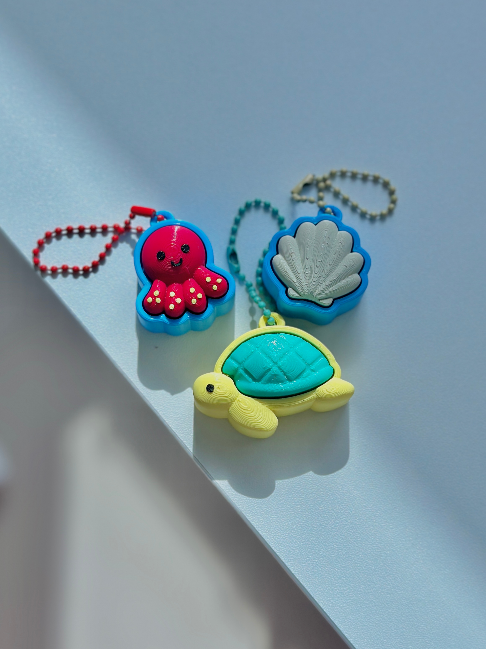 3D printed Sea Friends fidget toy keychains featuring a turtle, seashell, and octopus