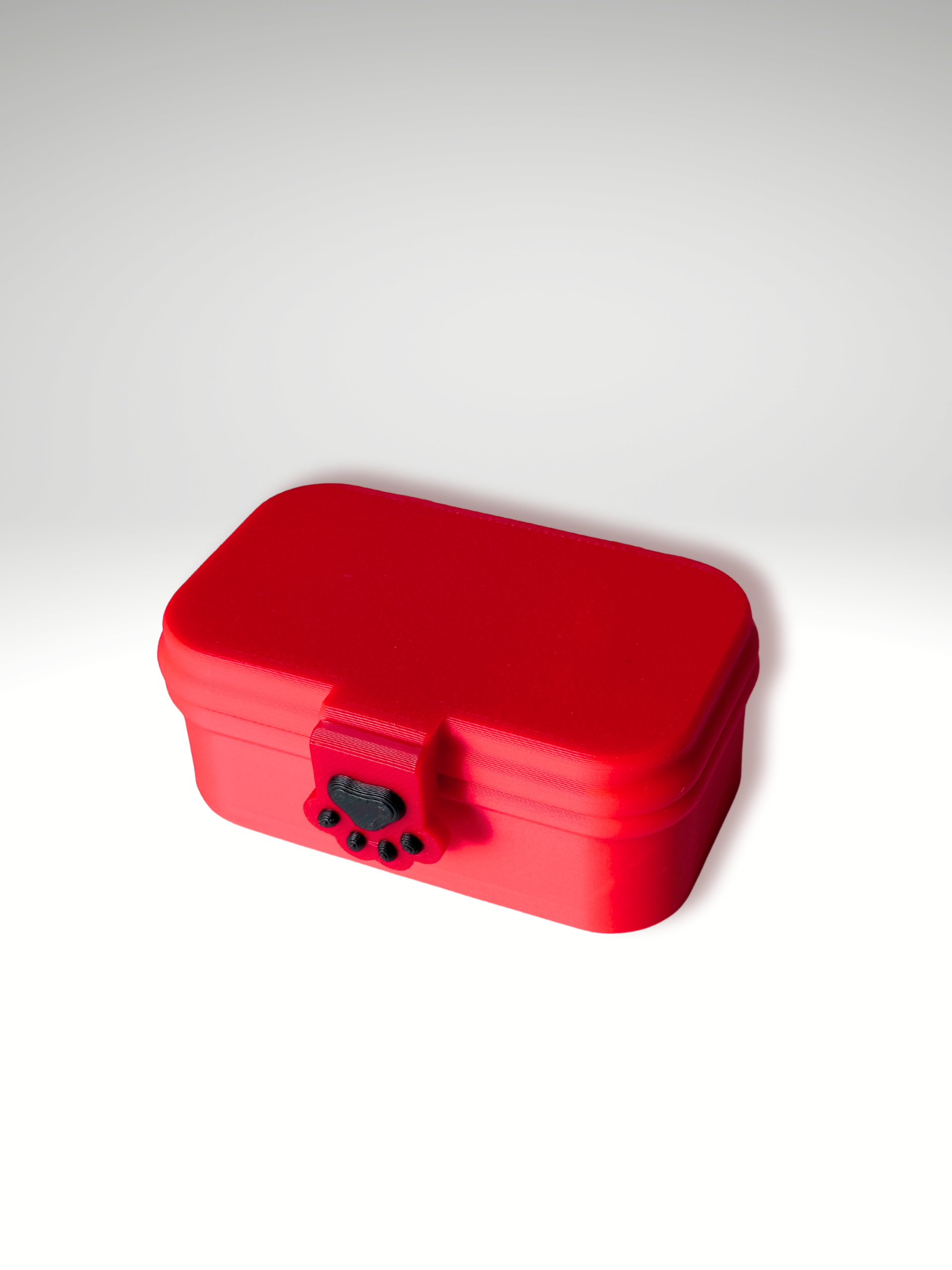 Red 3D printed bento box clicker toy shown closed with a detailed view of the paw-shaped lock mechanism