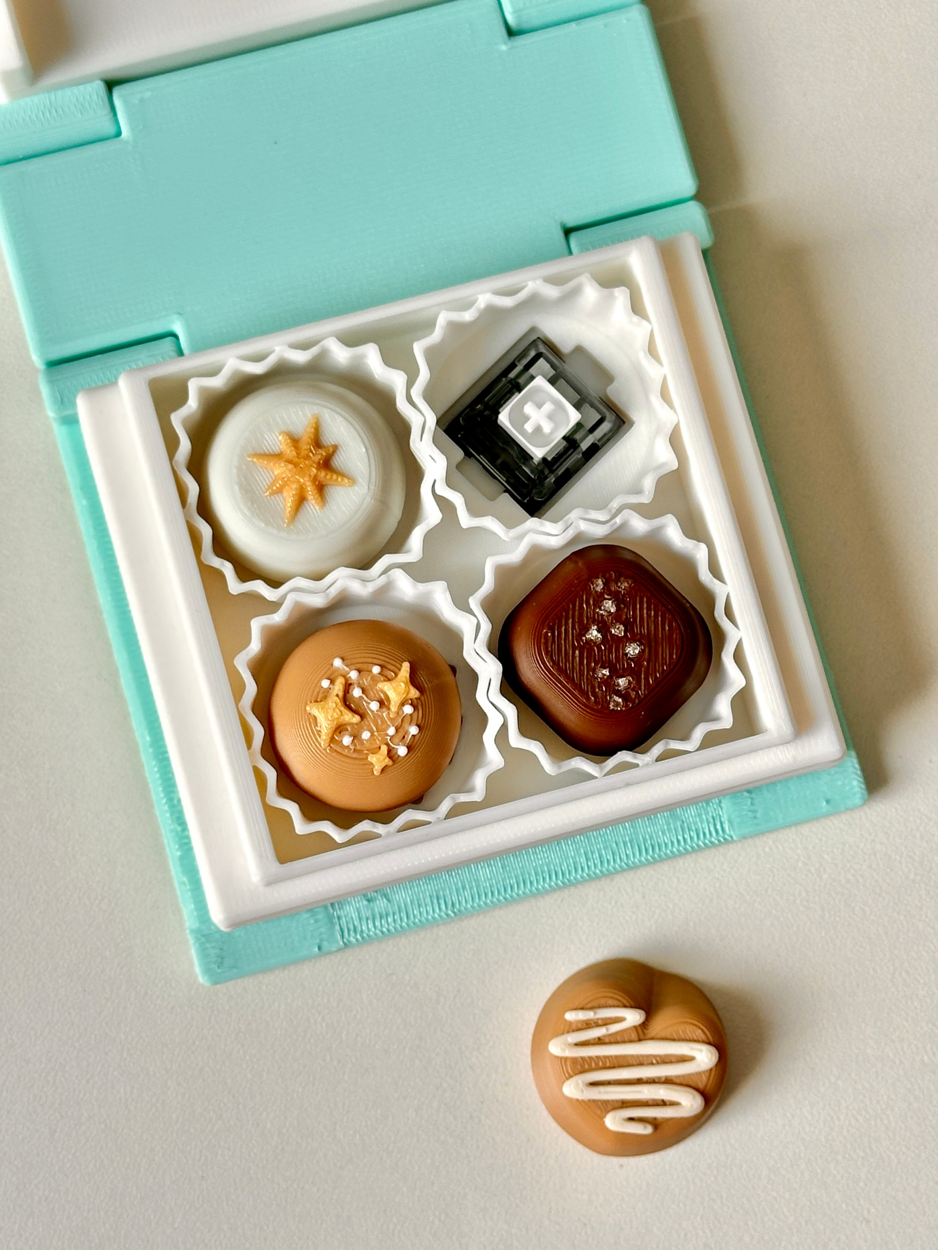 3D Printed Chocolate Book Box Clicker – Bonbon Chocolate Clicker Set in Decorative Book – product view | Dubai 3D Printing
