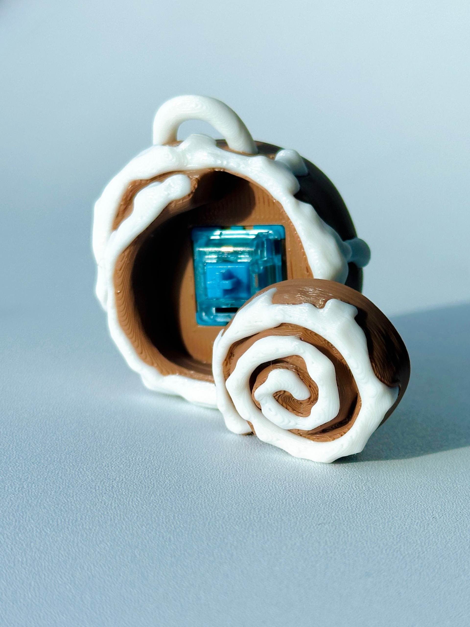 Close-up image of opened cinnamon roll clicker showing the internal mechanical switch