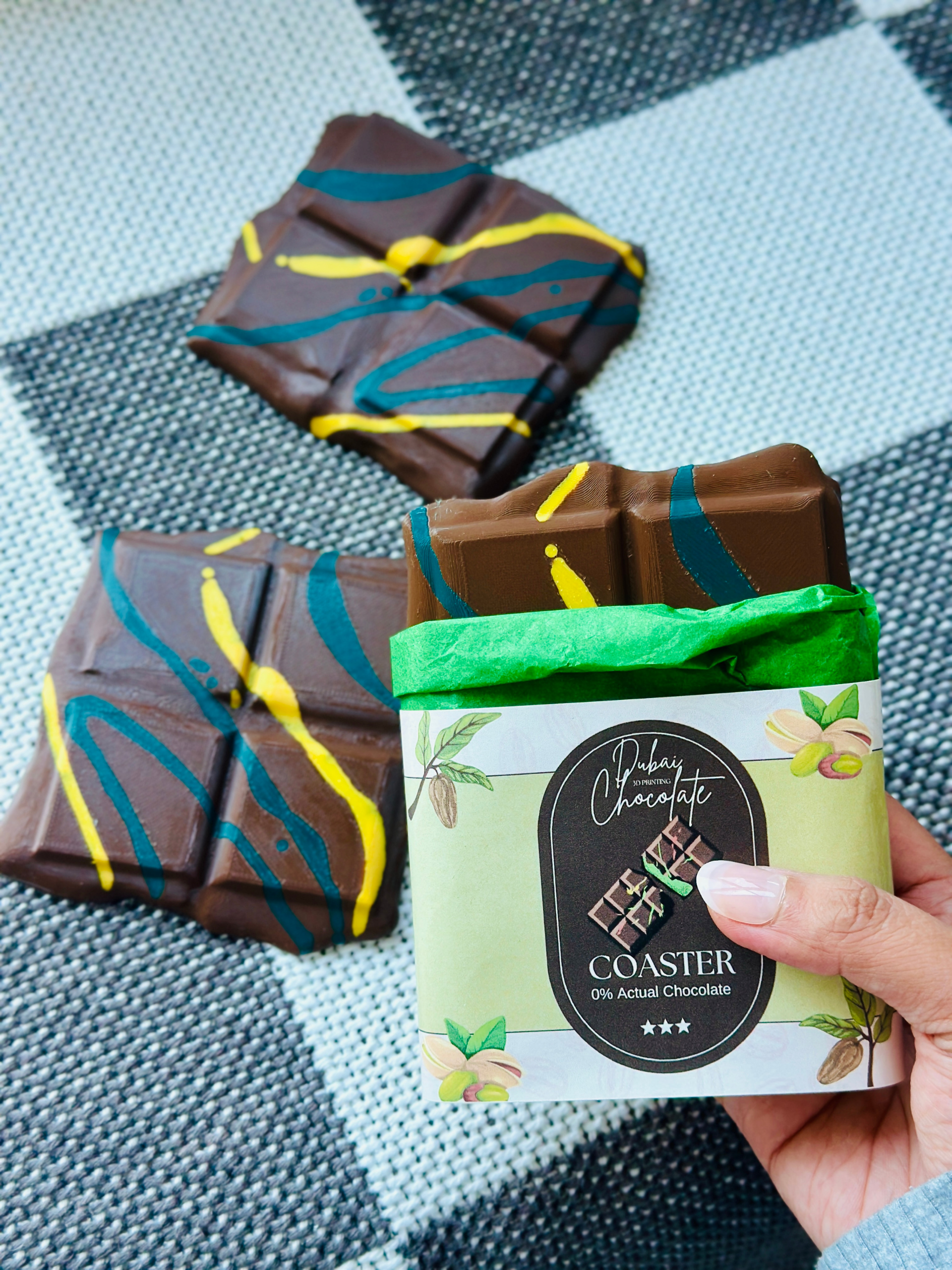 3D printed Dubai Chocolate Coaster held in one hand, showing size and lightweight feel