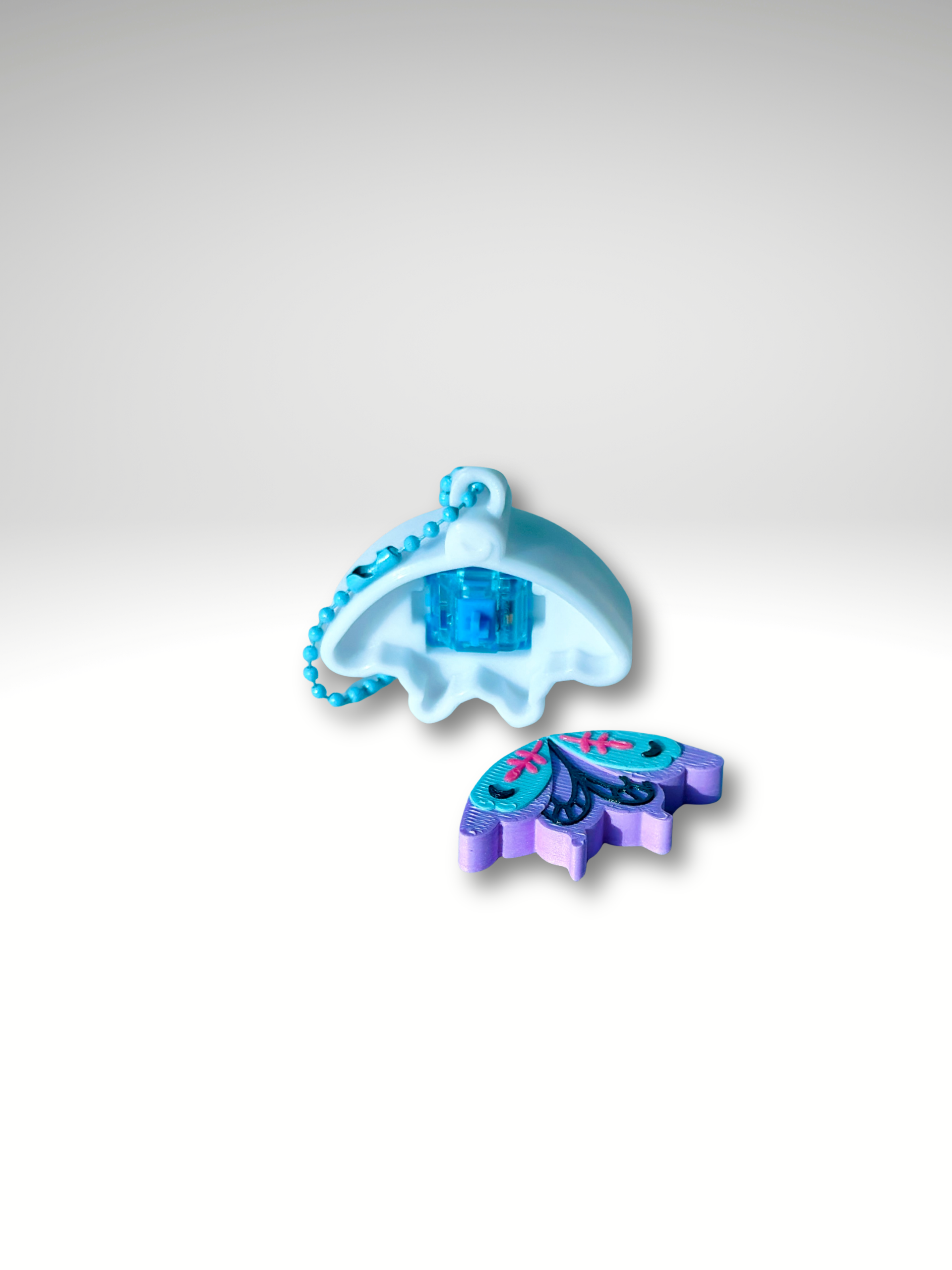 Light Pixie keychain showing a key switch for fidget clicking