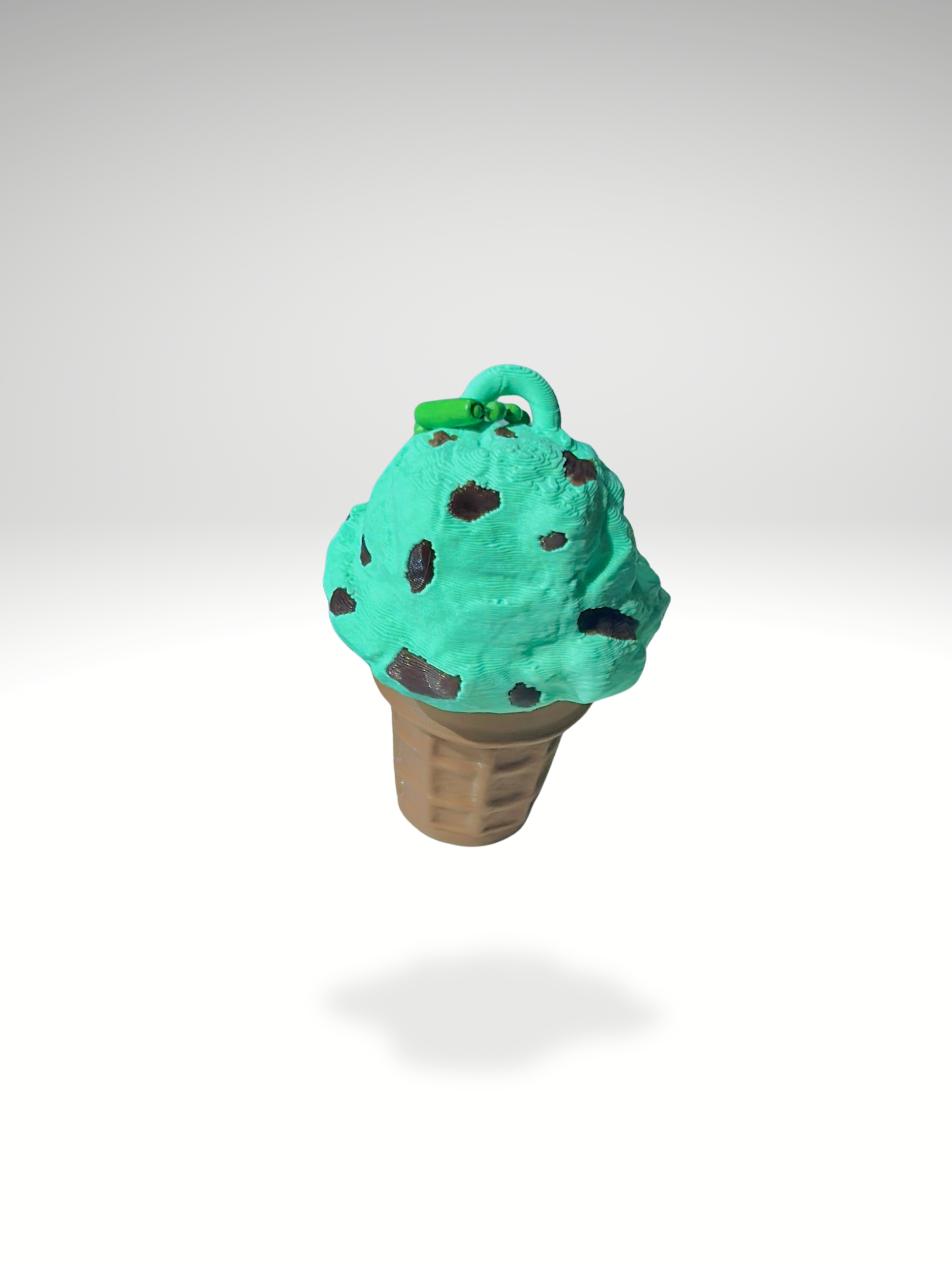 3D printed mint chocolate ice cream cone fidget keychain with mint green scoop and chocolate chips, shown on a white background