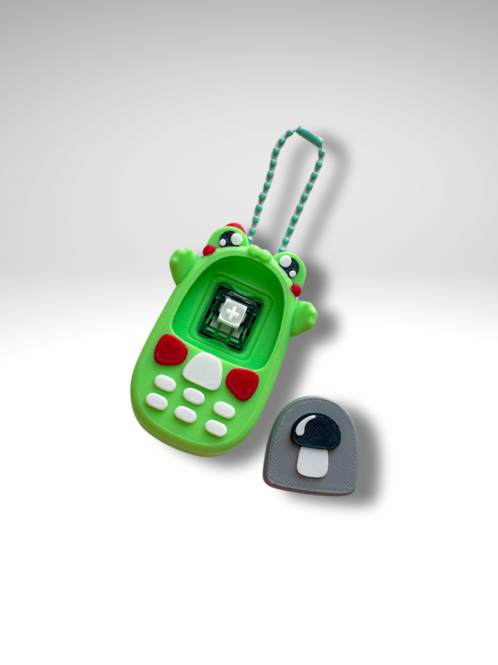 Retro Phone Clicky Pal with the screen tile removed, revealing the mechanical keyboard switch inside | Dubai 3D Printing