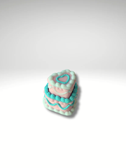 Three-tone pastel heart clicker in blue, pink, and white on a white backdrop.