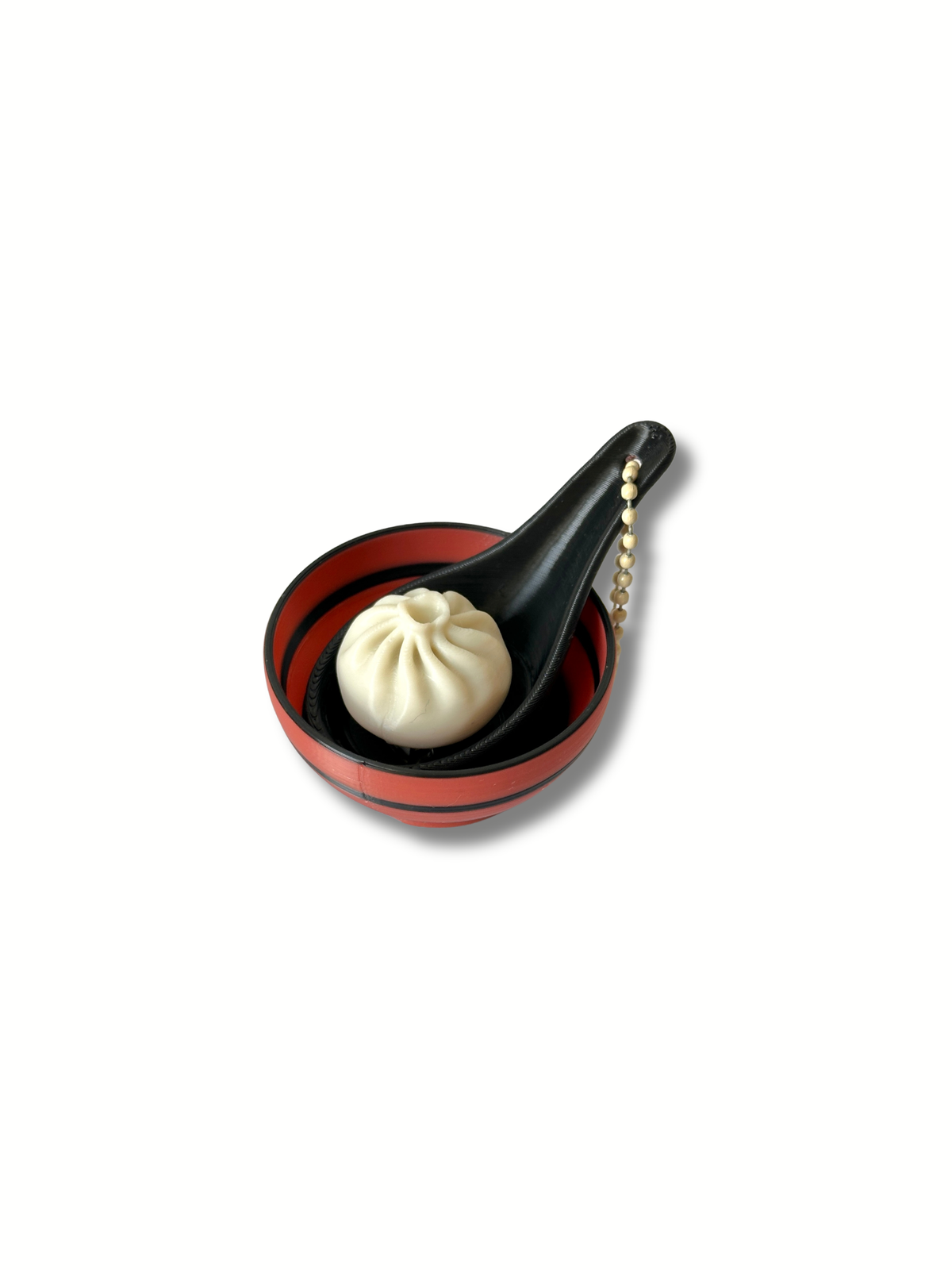 Baozi BBQ bun fidget clicker on black spoon in red lacquered bowl 3D printed Dubai