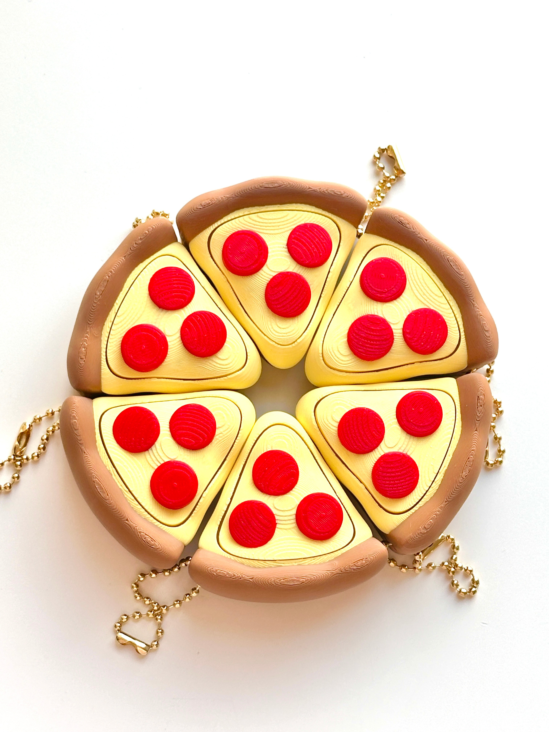 Six pizza slice Clicky Pals arranged into a full pepperoni pizza | Dubai 3D Printing