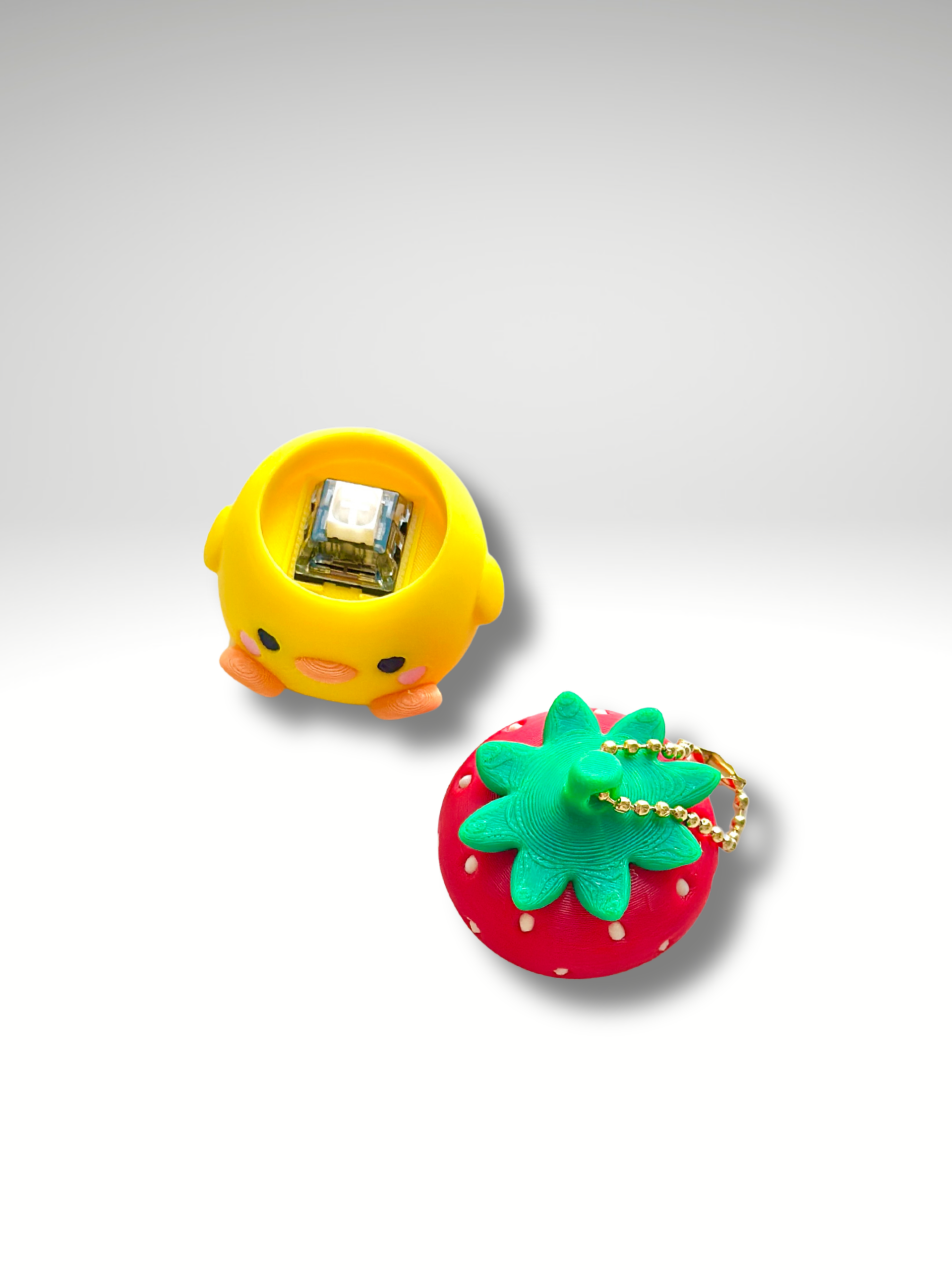 Strawberry Duck Clicky Pal with pop-off strawberry hat revealing the hidden mechanical switch | Dubai 3D Printing